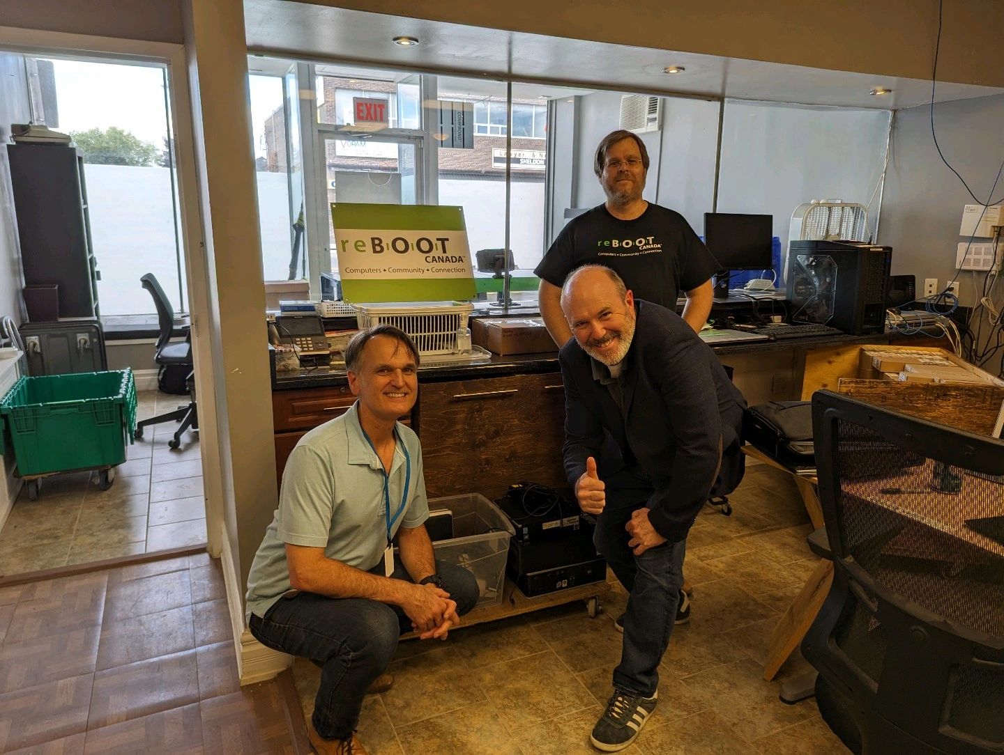 Jamie Johnson (center) helps Franc Rota and Lars Verholt organize the new office space.